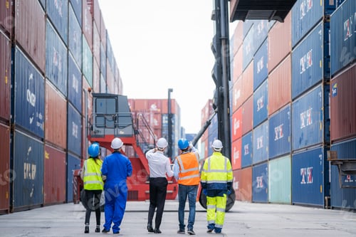 Preview: Manager and professional container yard workers checking stock for loading in the container yard.