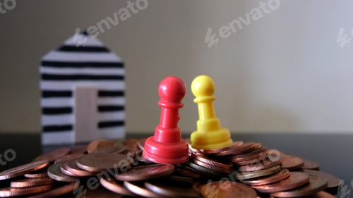 Preview: Chess stand on stack of coins.