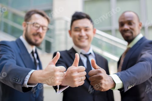 Preview: Close-Up Of Multi Ethnic Business Team Holding Their Thumbs Up. Three Men Hands Showing Thumbs Up