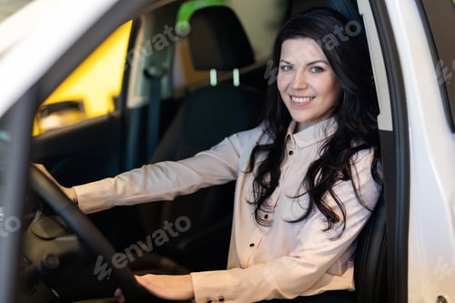 Preview: Happy customer woman buying a new car in dealeship center