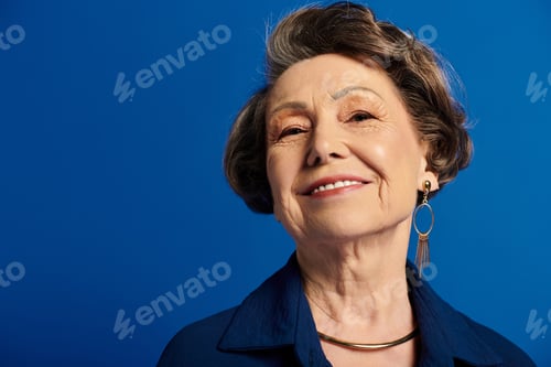 Preview: A beautiful woman in her 60s gracefully poses in chic fashion, radiating confidence and style.