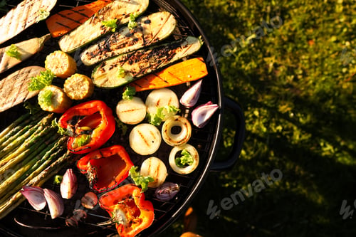 Preview: Delicious grilled vegetables on barbecue grill outdoors, top view. Space for text