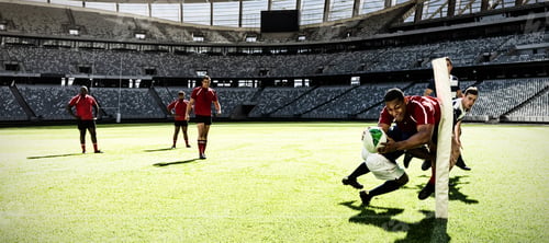 Preview: Digital composite image of two rugby players tackling each other in sports stadium
