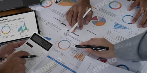 Preview: Business People Meeting using laptop computer,calculator,notebook,stock market chart paper for