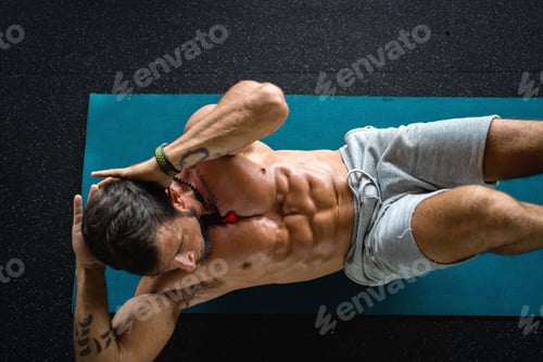 Preview: Strong and fit man doing abs in a gym