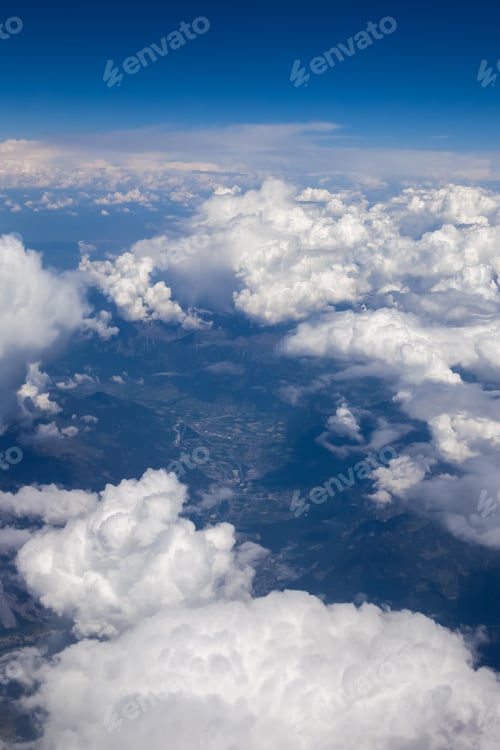 Preview: Fluffy white clouds, a view from airplane window
