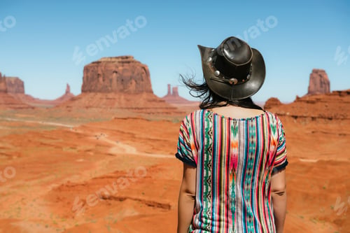 Preview: USA, Utah, Woman with cowboy hat enjoying the views in Monument Valley