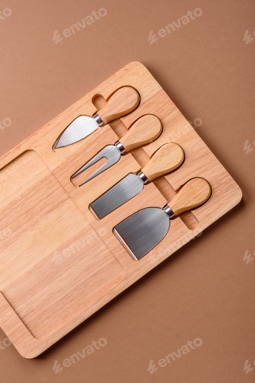 Preview: A set of cheese knives with a wooden cutting board, slicing tools. Cheese knives