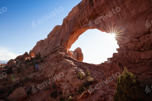 Aperçu: Scenic landscape of an Arch rock formation during a vibrant sunny day