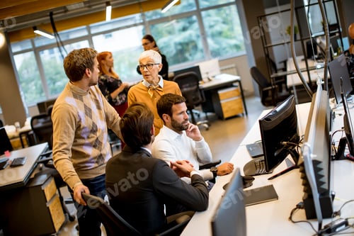 Preview: Senior businesswoman and young business people work in a modern office