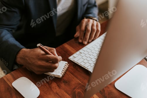 Preview: Businessman working at his desk
