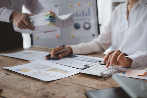 Preview: Businessmen are opening up their laptop's financial information for business partnerships.