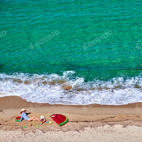 Preview: Boy and his mother on beach with inflatable float