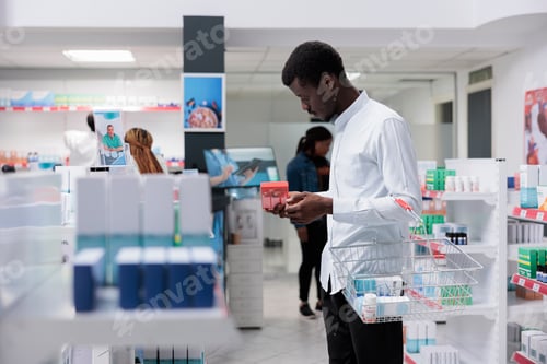 Preview: African american man checking prescription heart treatment in drugstore