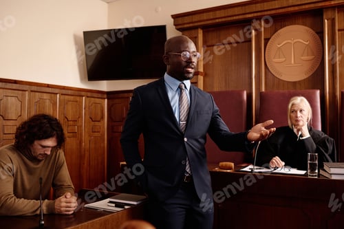 Preview: Confident attorney in formalwear speaking to prosecution side during trial