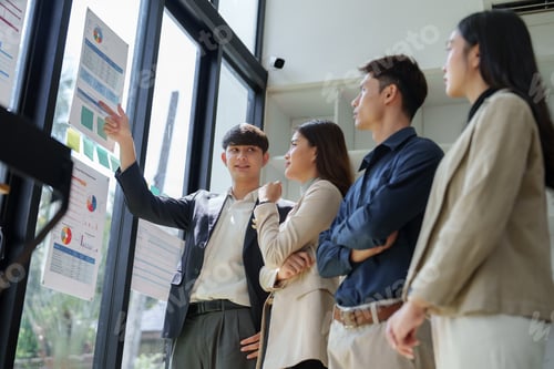 Preview: Business team analyzing data during meeting presentation