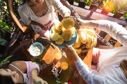 Preview: Group Of People Eating Breakfast Together Enjoy Fresh Pineapple Young Unrecognizable Man And Woman