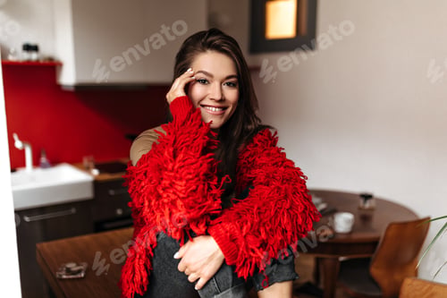 Preview: Brunette woman in great mood is smiling. Portrait of brown-eyed lady in bright sweater and beige t-