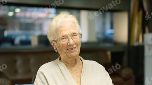 Preview: Woman senior smiling at camera sitting in a nursing home