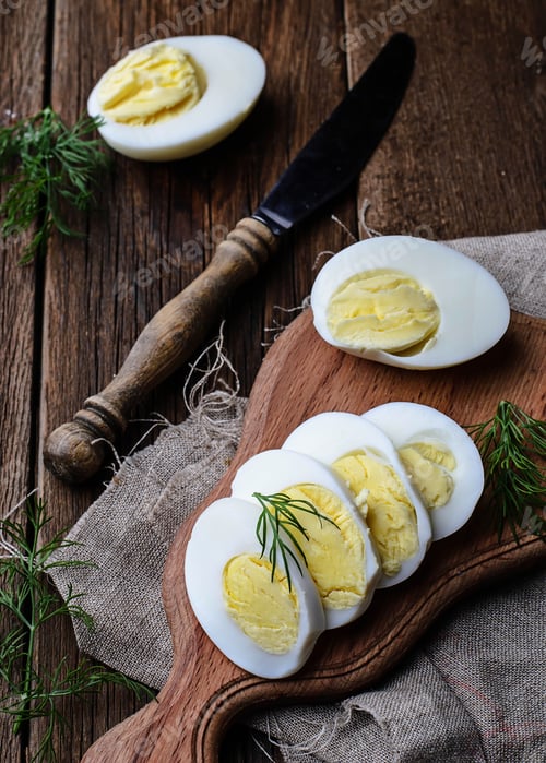 Preview: Boiled sliced chicken eggs on board