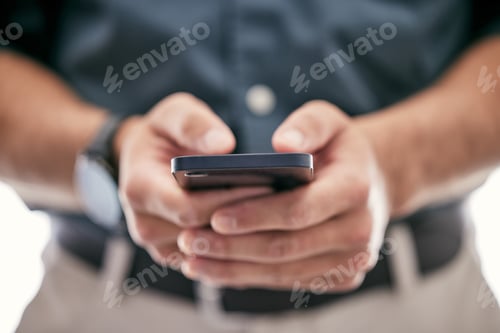 Preview: Shot of an unrecognizable businessman using a smartphone in a modern office