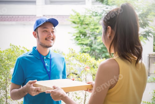 Preview: Asian Woman accepting a delivery pizza box