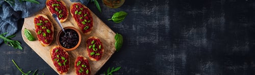 Preview: Bruschetta with grated beetroot, herbs and caramelized onion. Top view