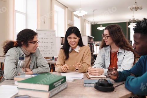 Preview: Young Asian Woman with Multiethnic Group of Students at Table