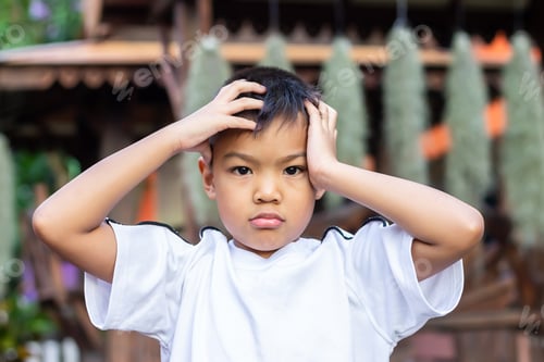 Preview: 6-7 years old child. Alone Asian little boy feel sad, headache and stressed.