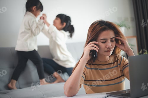 Preview: Home office. Working from home vs. Mom with two kids Work on the Internet on a laptop at home.