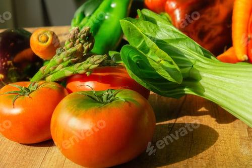 Preview: Closeup of ripe tomatoes with herbs on a wooden table