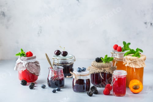 Preview: Assortment of seasonal berries and fruits jams in jars
