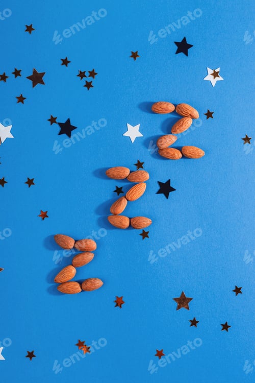 Preview: Z-shaped almonds as a product to restore healthy sleep and treat insomnia. Top view, flat lay