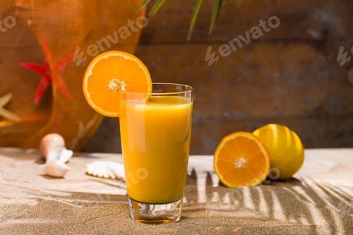 Preview: Glass of orange juice on a beach table