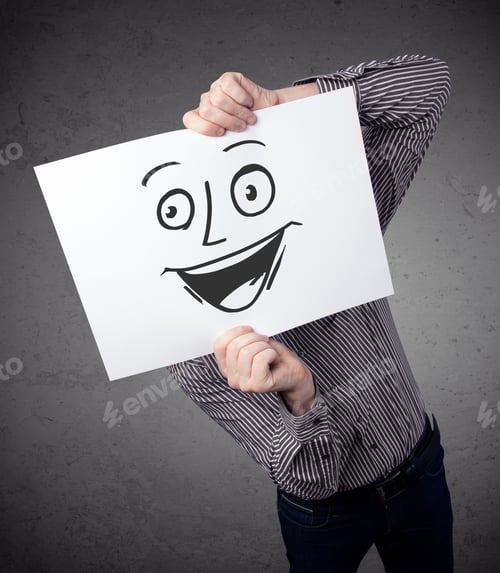 Preview: Young Businessman Holding A Cardboard With A Smiley Face On It In Front Of His Head
