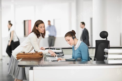 Businesswoman Giving Card to Office Receptionist