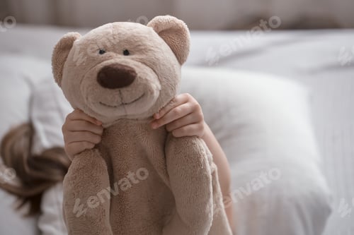Preview: Little cute girl in bed with toy