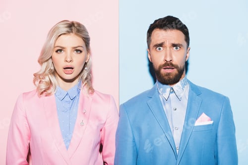 Preview: shocked woman and handsome man looking at camera on pink and blue background