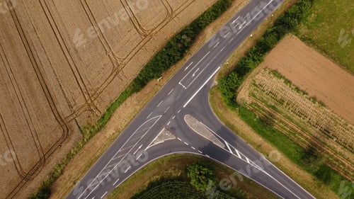 Preview: Aerial view of a street surrounded by fields
