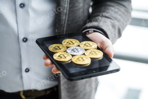 Preview: Business man pressing button bitcoin on tablet
