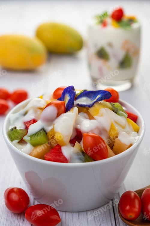 Preview: Fruit salad in a bowl on the wooden floor.