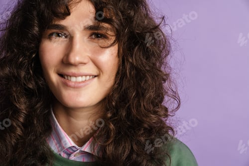 Preview: Happy beautiful curly girl smiling and looking at camera