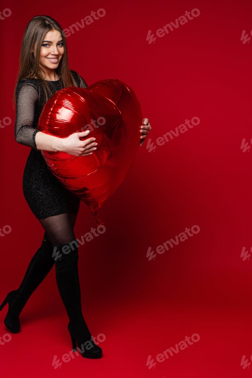 Preview: Beautiful Brunette Carrying Heart-Shaped Balloon. Saint Valentine Concept.