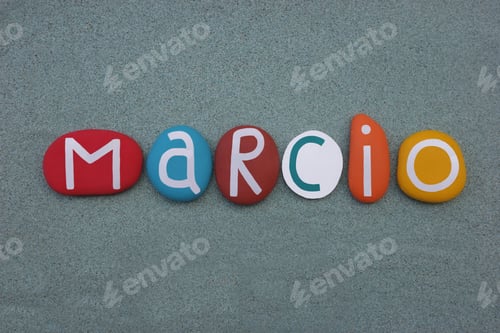 Preview: Marcio, masculine given name composed with multi colored stone letters over green sand