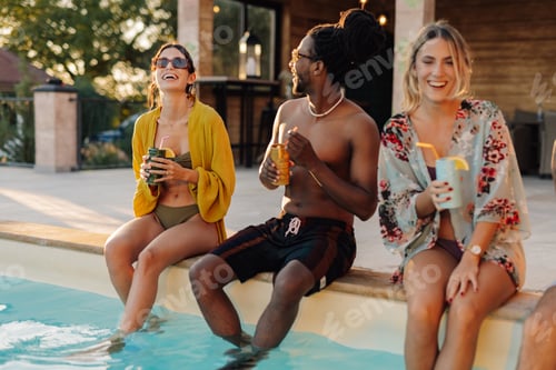 Preview: Friends enjoying drinks at poolside during summer vacation