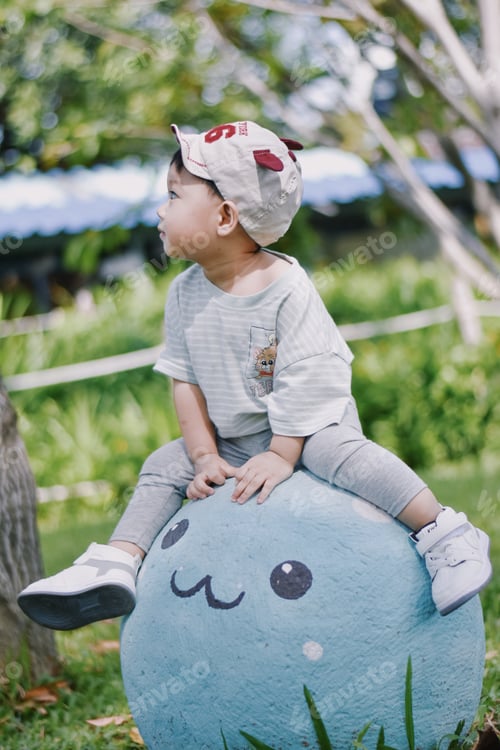 Preview: happy little boy playing on playing on the playground at the day time