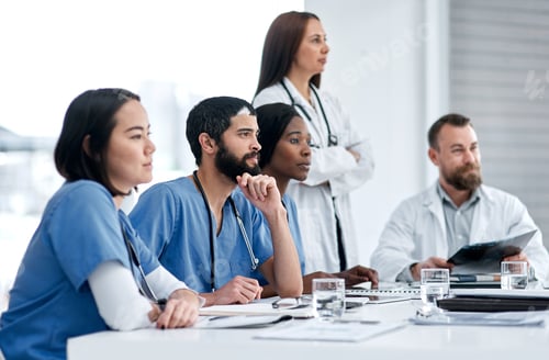 Preview: Shot of a doctor sitting alongside his colleagues during a meeting in a hospital boardroom