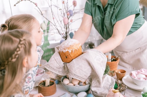 Preview: happy easter holiday time in spring season. beautiful young housewife woman holds a freshly baked pa