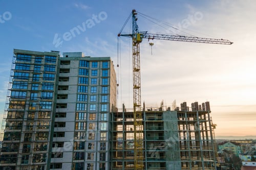Preview: Aerial view of high tower crane and residential apartment building under construction