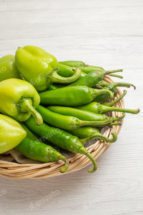 Preview: front view green spicy peppers with bell-peppers inside basket on a white background color hot edgy